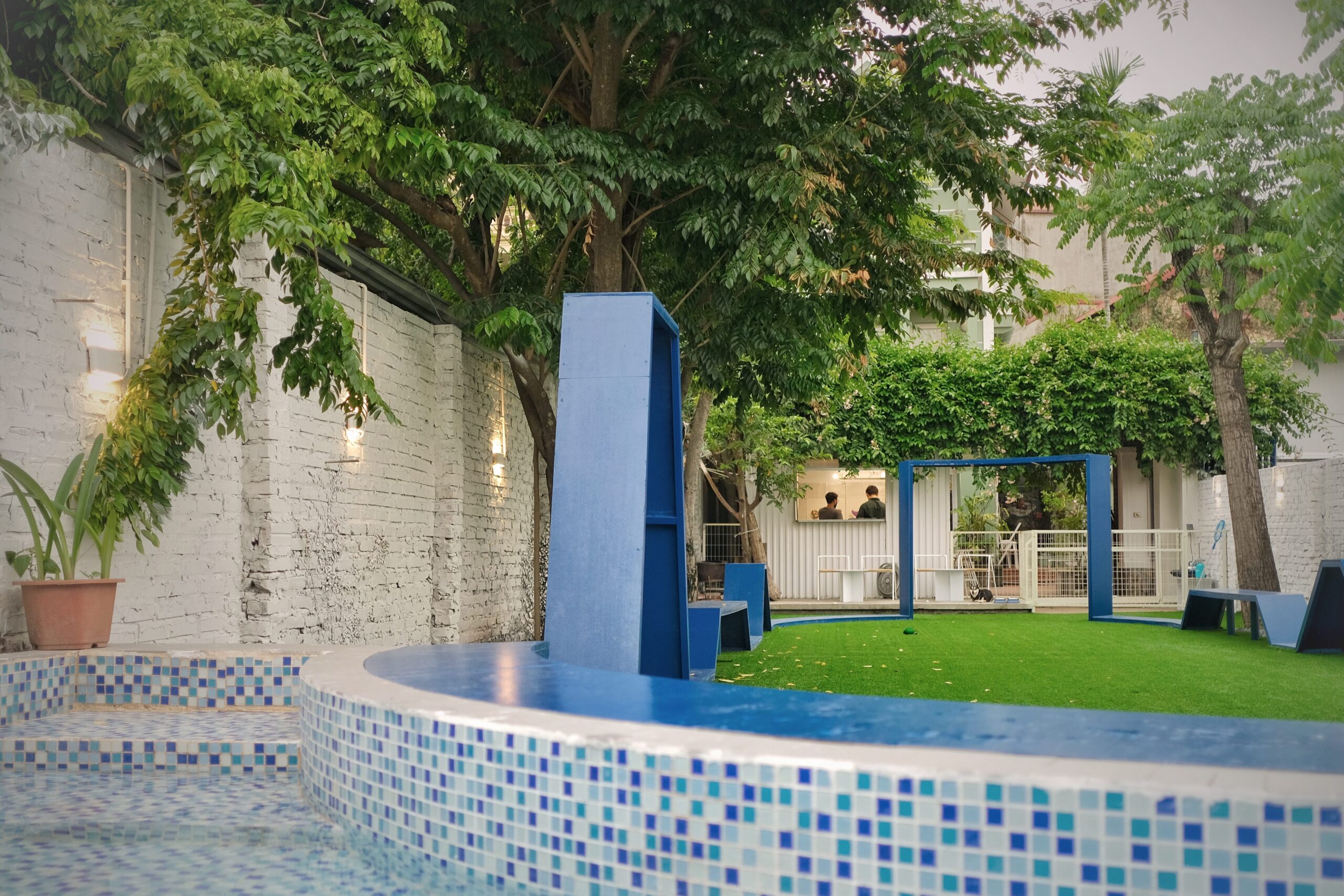 PupHub dog park facility — pool, agility area, and seating in Tay Ho, Hanoi